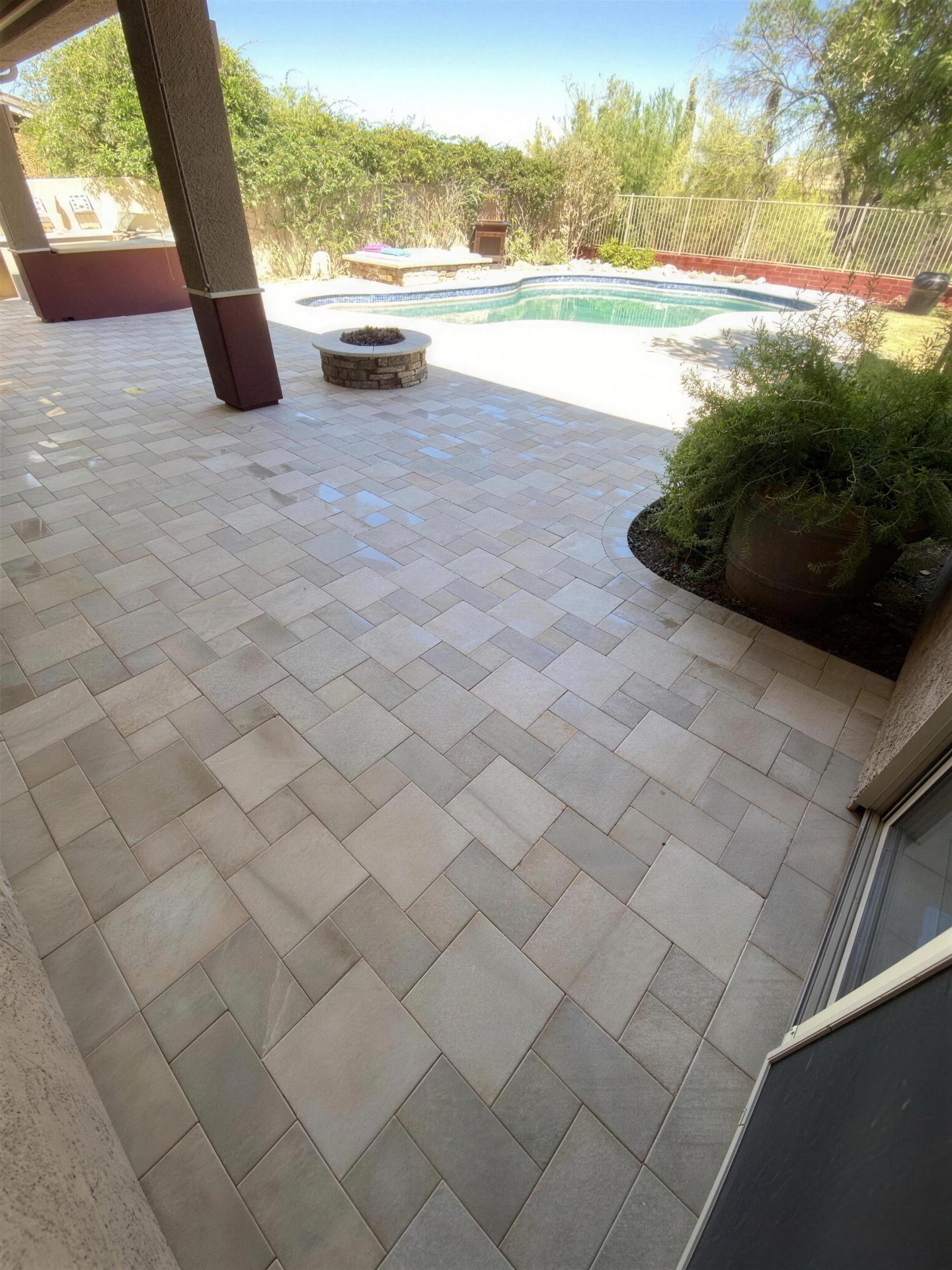 Paver patio and gas fire pit beside the pool