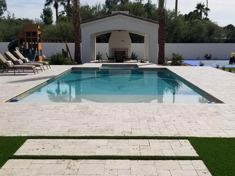 Travertine pool deck and patio with turf accents