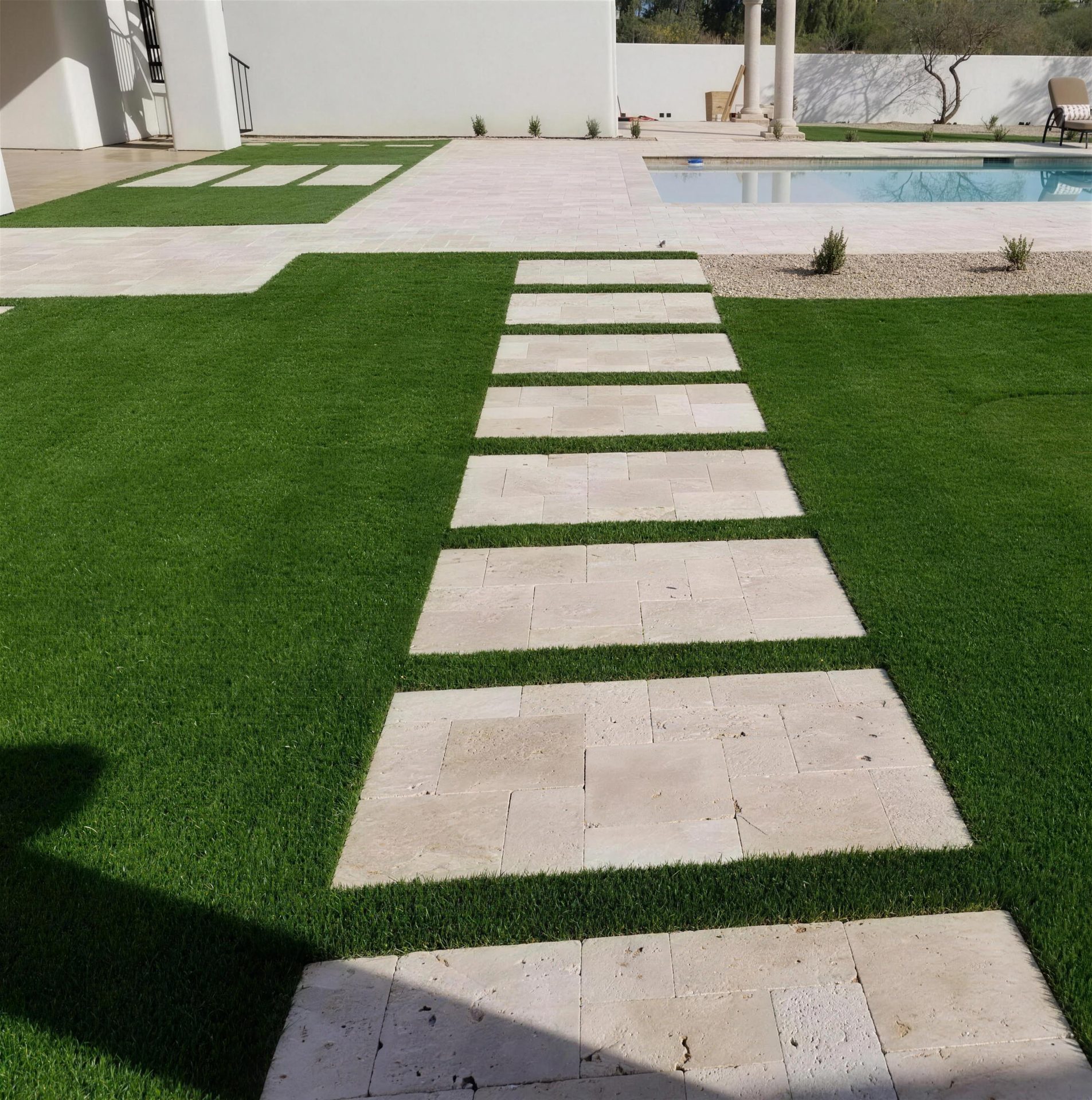 Travertine stepping pads set into artificial turf